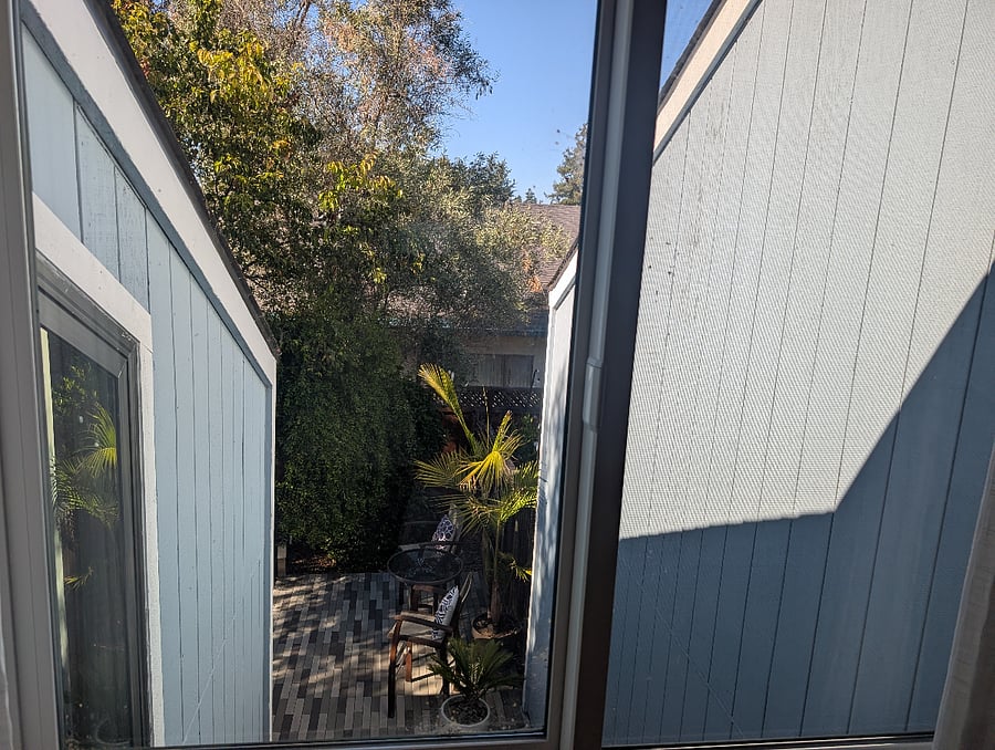 View from master bedroom into backyard - the right wall is the neighbor unit