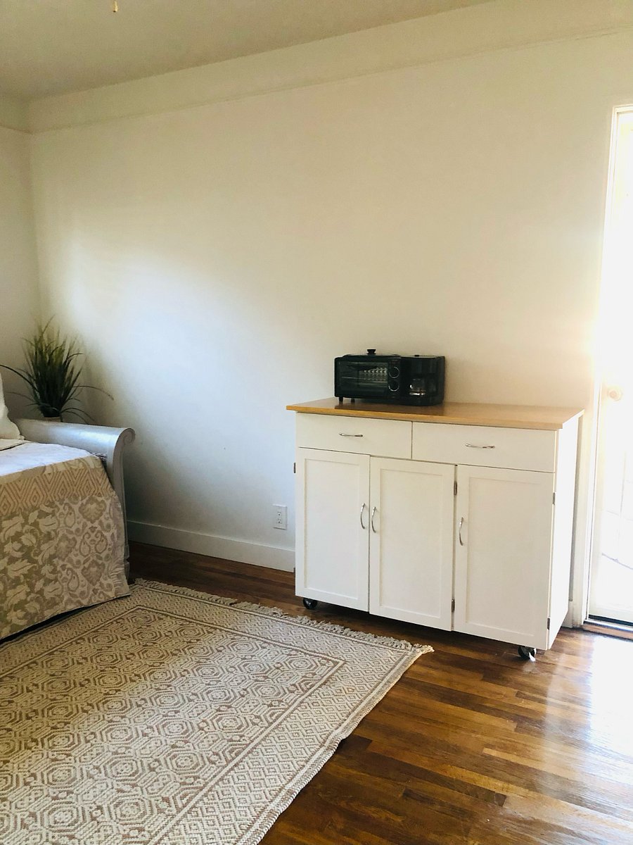 kitchenette with coffee maker, toaster, microwave and small fridge