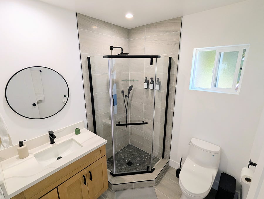 Bathroom. Shower with wand, sink, toilet.