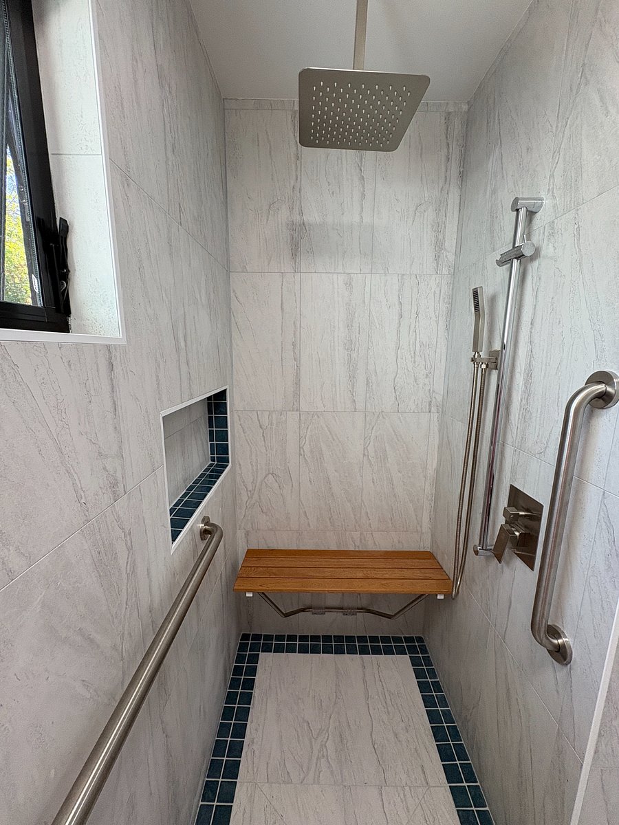 Walk-in shower stall with rainfall shower, folding bench and adjustable hand-held shower