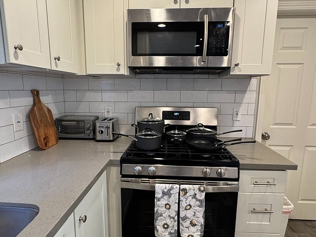 Gas range/oven with built-in microwave; small toaster oven and pop-up toaster included with full set of pots and pans shown