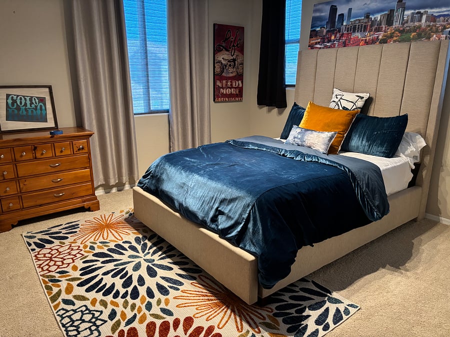 Your bedroom. There is a tv hung on the wall in front of the bed.