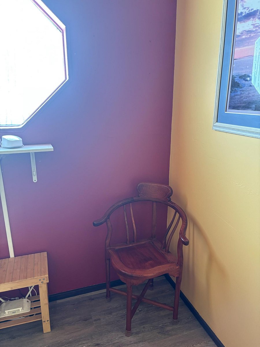 Top of the stairs with corner chair for item and or shoe removal.