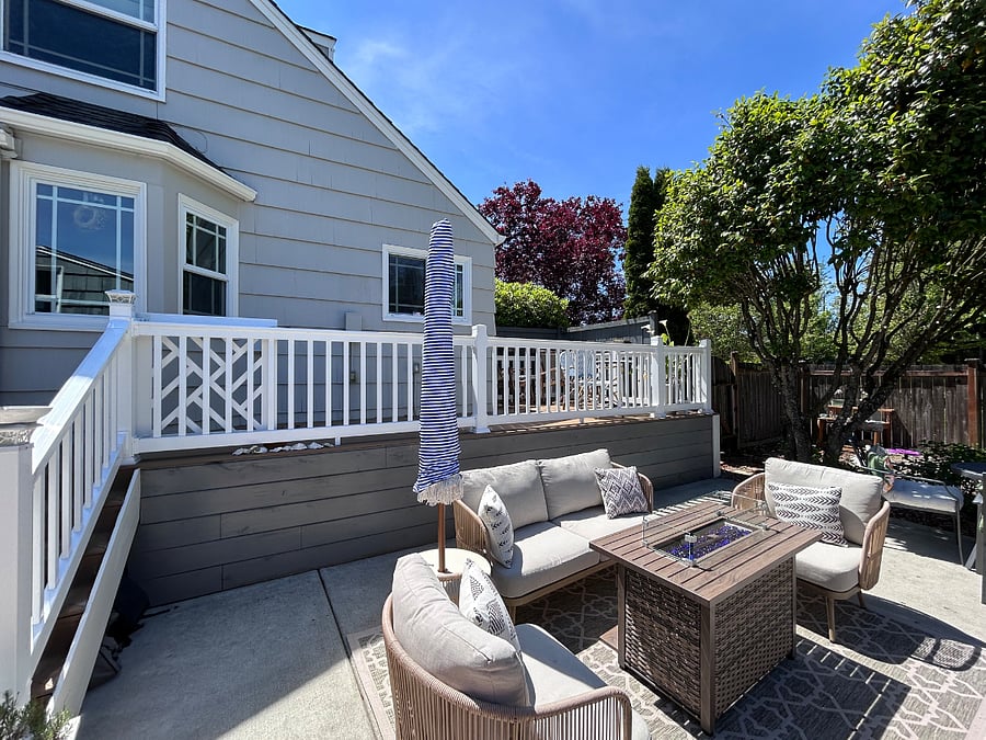 Shared back yard with grill and seating area.