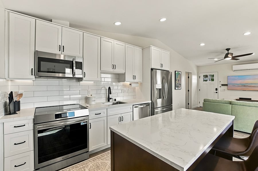 This counter-height kitchen island is great as a workspace and for meals. Very comfy leather stools. Induction range uses stainless steel pots and pans, which are provided.