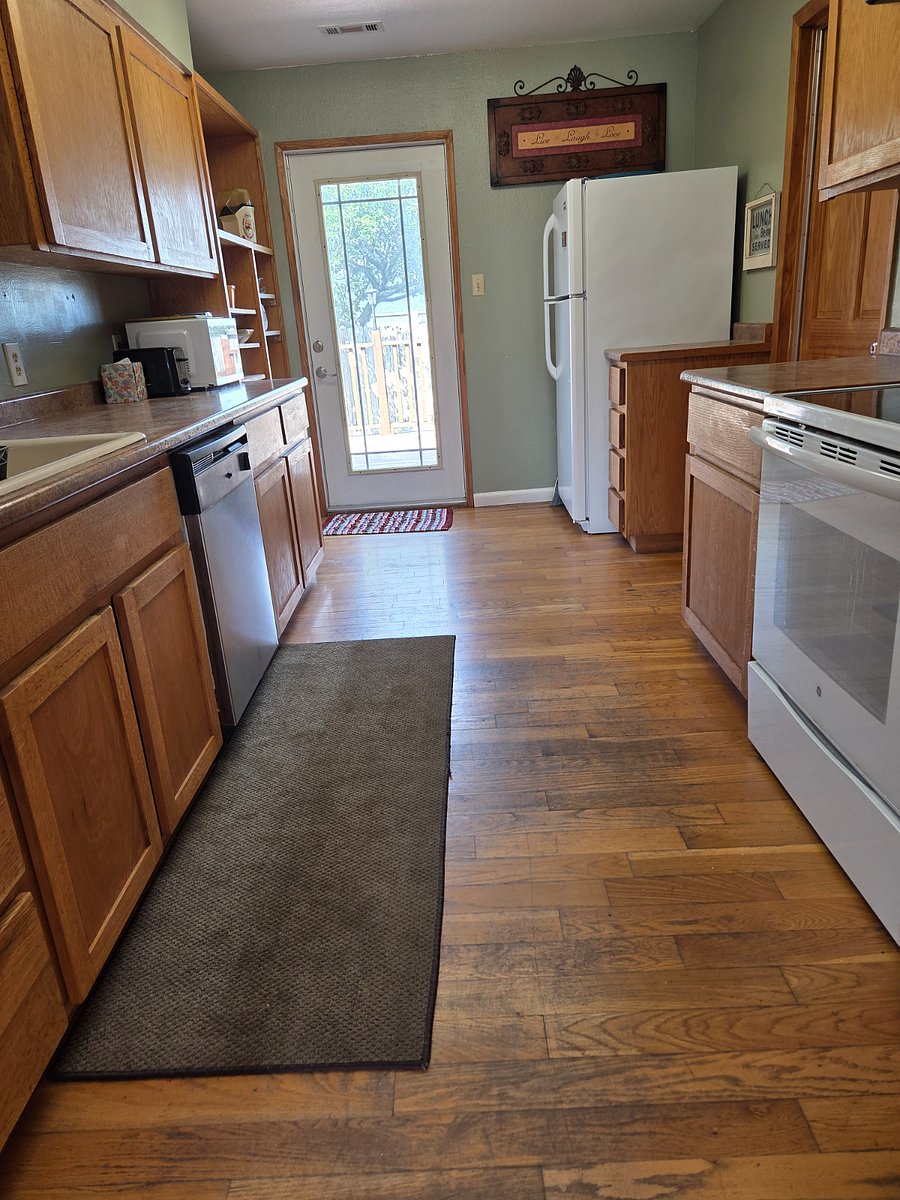 Walk through kitchen to deck and fenced yard.