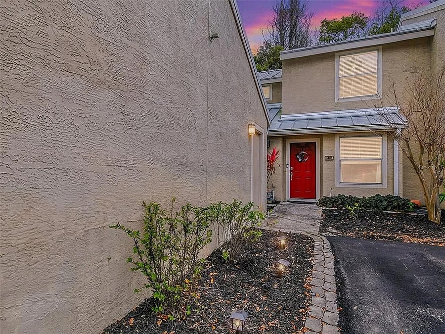Exterior of home with side view of single car detached garage