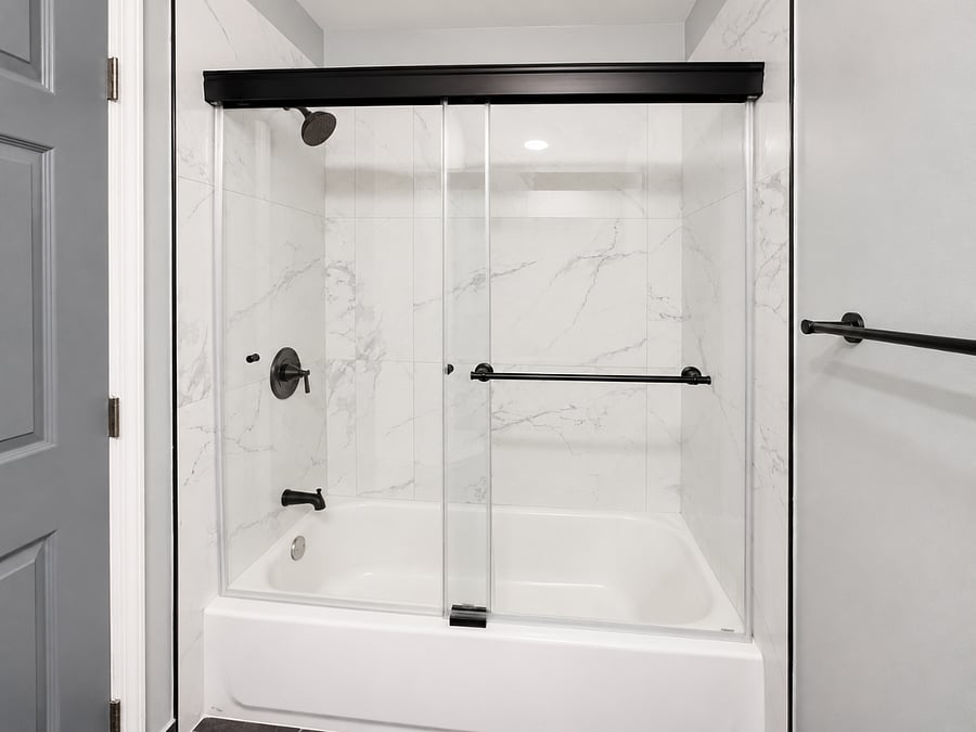 Tub and rain shower. Glass Door.