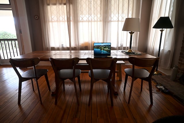 Full of light front room with dining/work table and chairs. 
