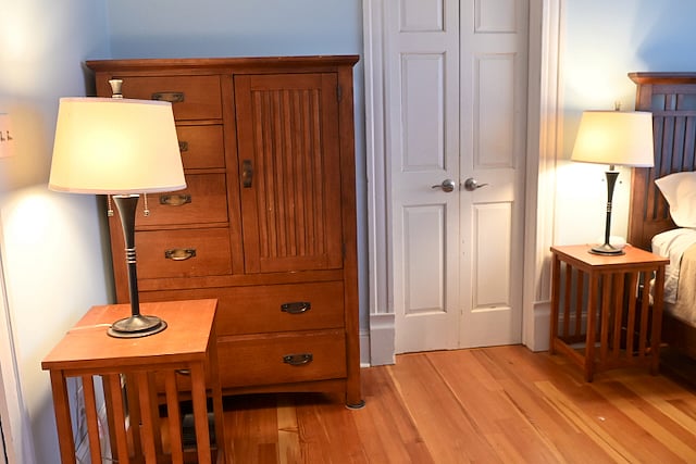 Queen Bedroom with queen sized bed, dresser, and two closets. 
