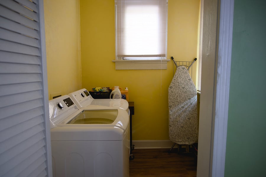 Laundry Room with washer, dryer, iron and ironing board.