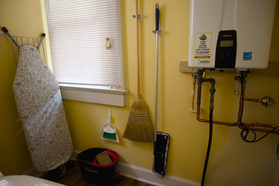 Laundry Room with washer, dryer, iron and ironing board.