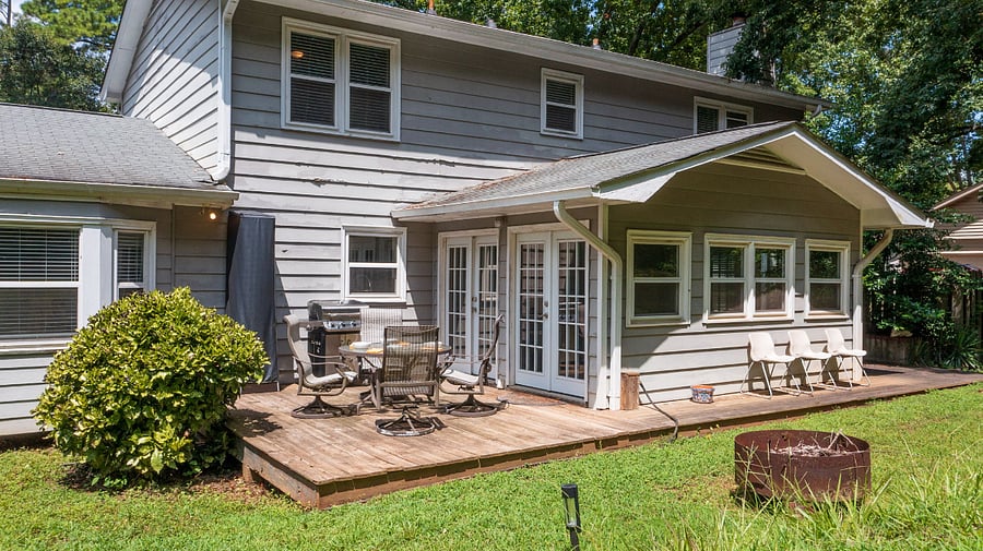 Seating, firepit and bbq grill in fenced backyard