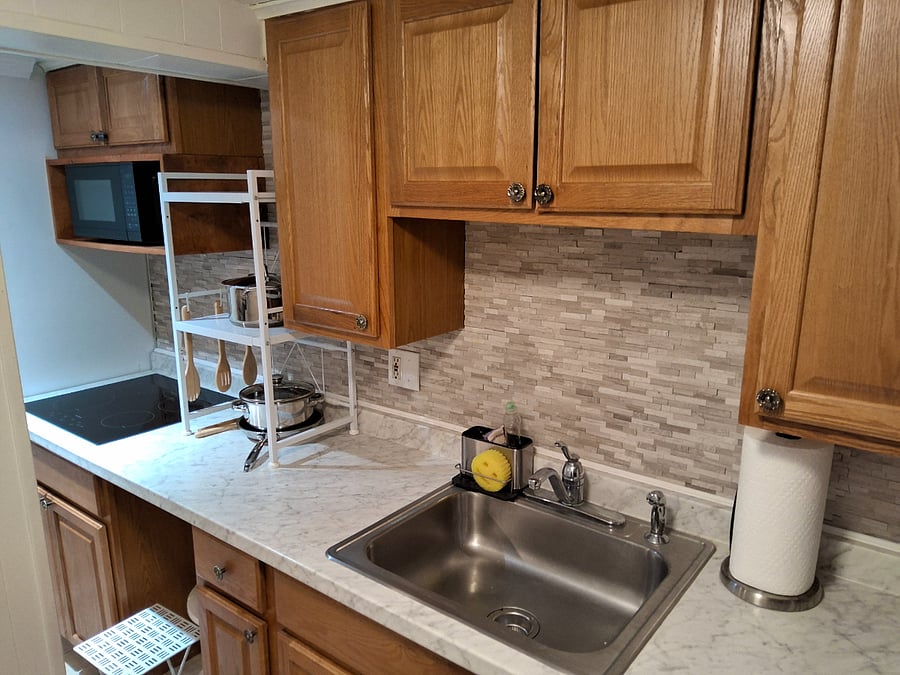 Kitchen area with microwave and refrigerator.