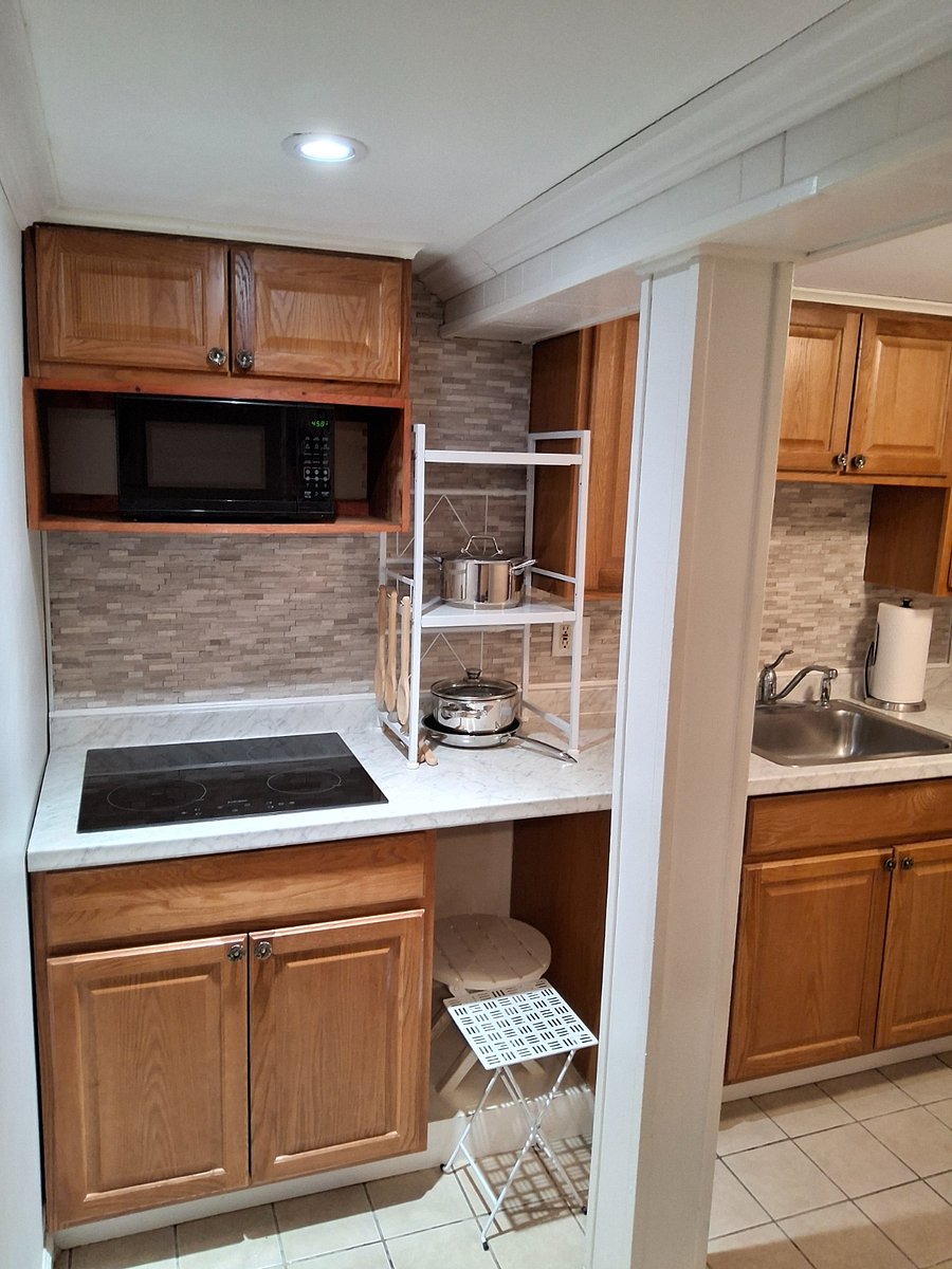 Kitchen with all basic appliances and utensils.