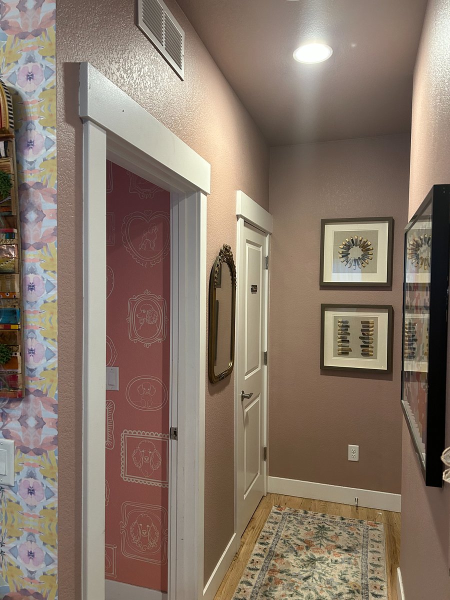 Hallway that leads to the Master, guest bathroom, and utility room with the laundry, pantry, and garage access.