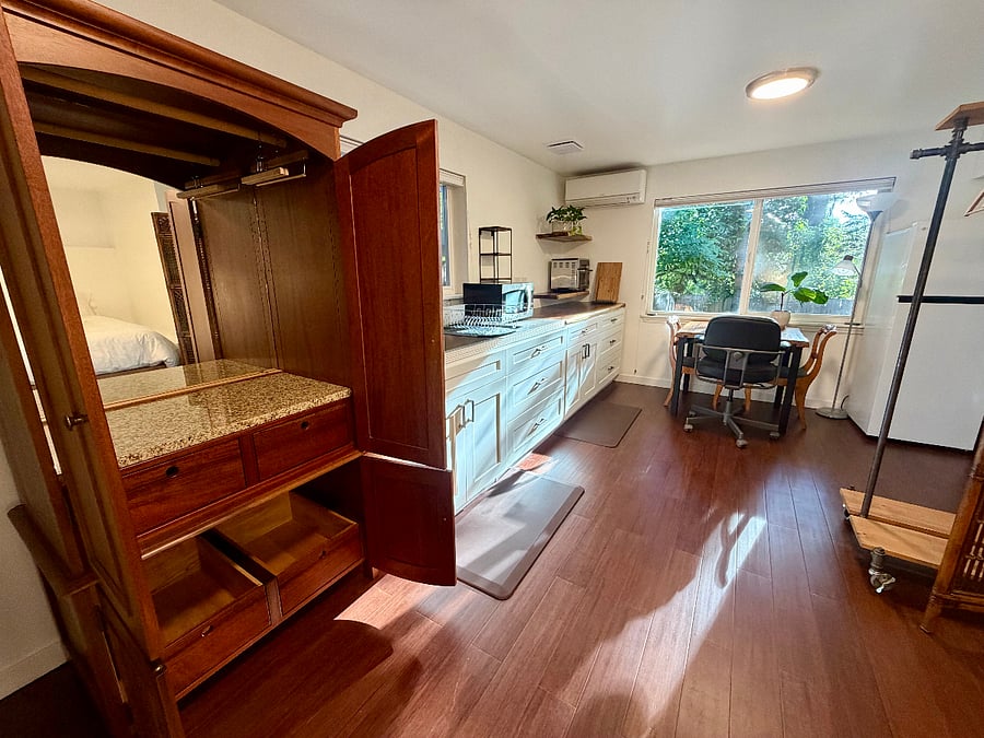 This beautiful solid wood cabinet with granite inlay and mirror, has a clothing rod and beautiful drawers.