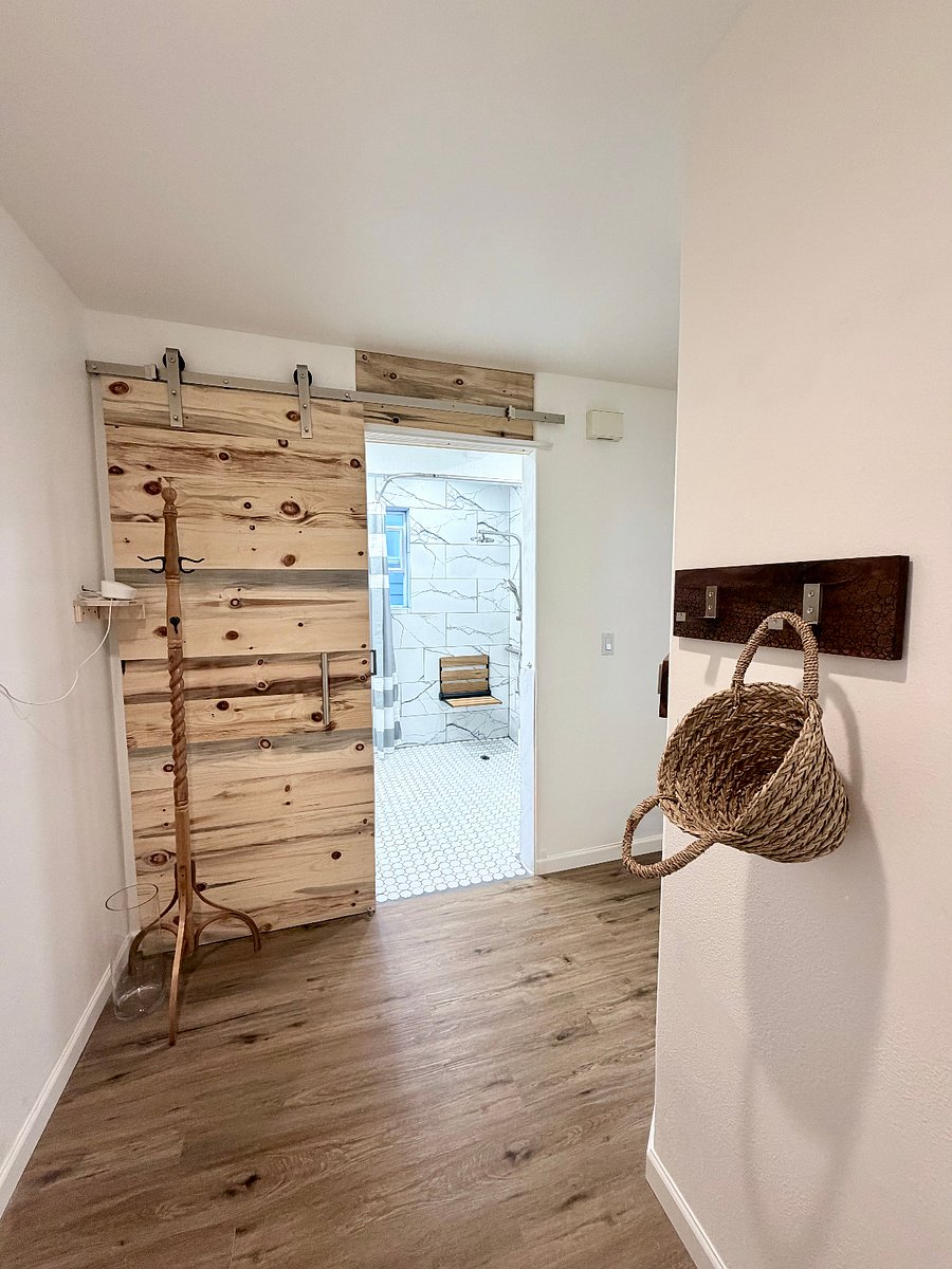 Foyer to bathroom. Hallway on right leads to kitchen, dining, & living.
