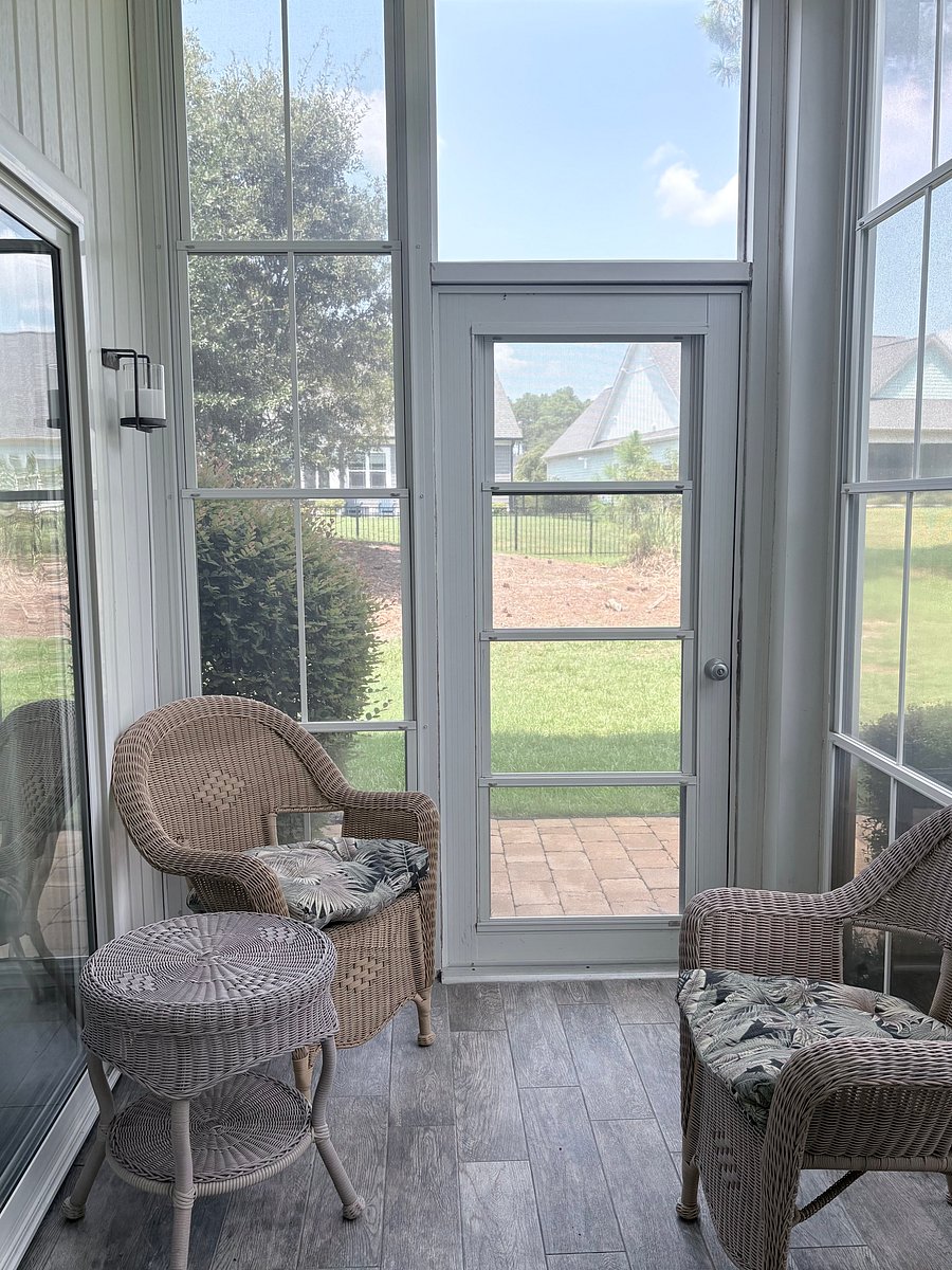 All weather screened in porch with easy breeze windows off of Main Villa with small outdoor patio