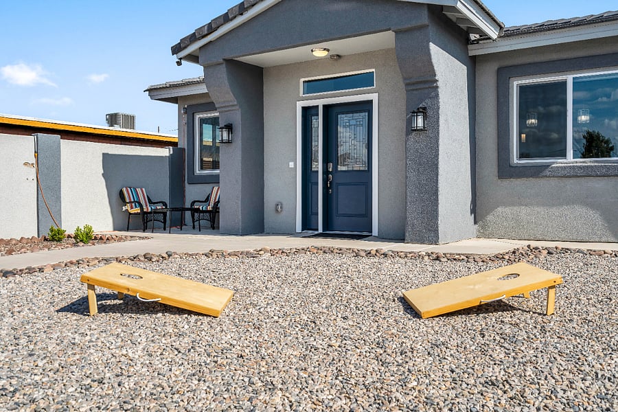 Private entrance with outdoor seating and cornhole for enjoying Tucson's sunny weather and warm desert evenings.