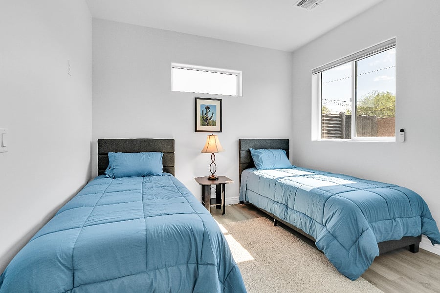 Perfect for kids, friends, or additional guests, this bedroom offers two comfortable twin beds and bright natural light.