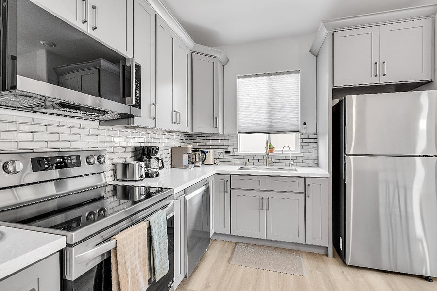 Modern kitchen stocked with cookware, dishes, and essentials to make preparing meals during your stay simple and convenient.