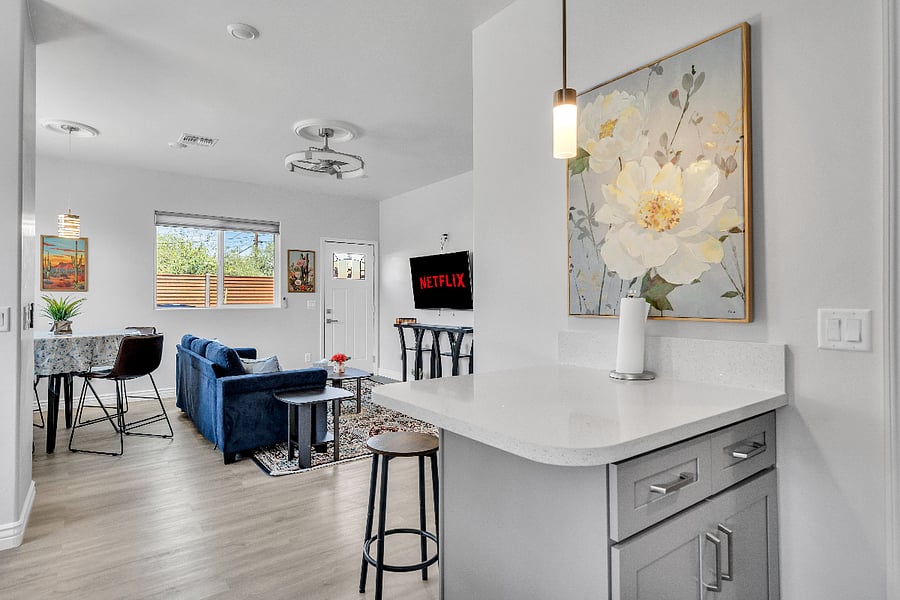 The open floor plan seamlessly connects the kitchen, dining area, and living room, creating a spacious and welcoming gathering space.