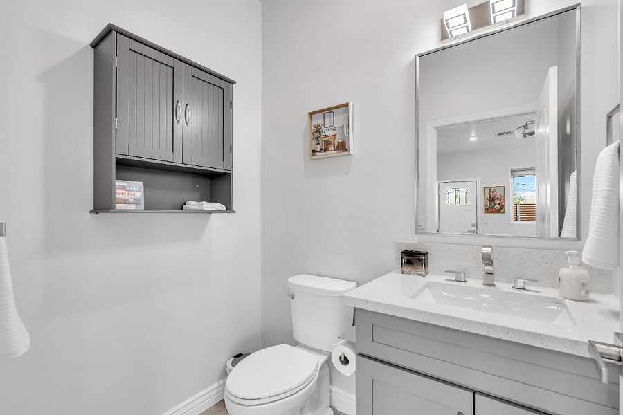 Convenient half bathroom located near the main living area, providing extra comfort and functionality during your stay.
