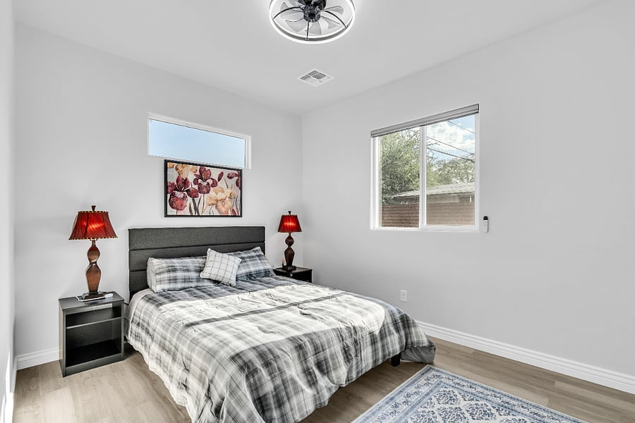 Comfortable primary bedroom featuring a queen bed, soft linens, and a relaxing atmosphere designed for restful nights.