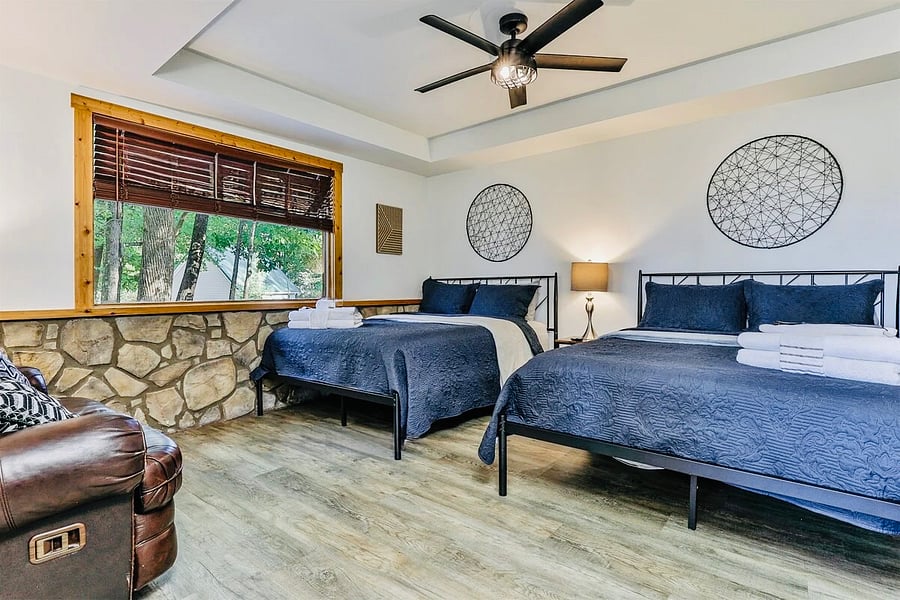 Lower level bedroom with 2 queen beds and a loveseat.