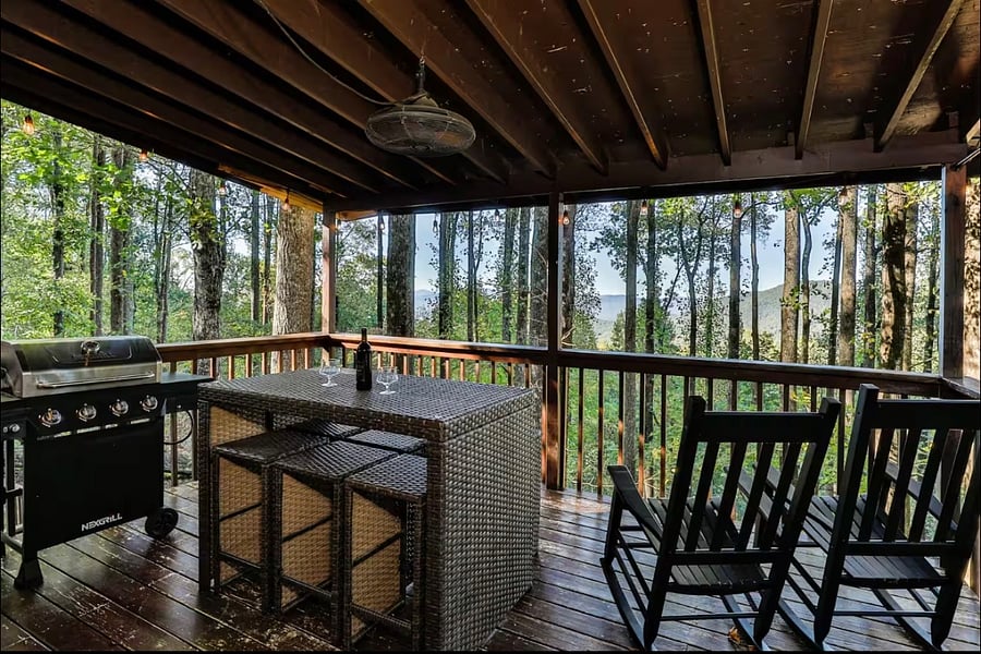 Main level deck with bar seating for 6, 2 rockers and a propane grill!