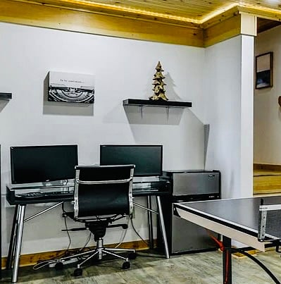 Dual Monitors for plugging in your laptop or for connecting Xbox. Full work style desk with a mini fridge on the side on the lower level. 