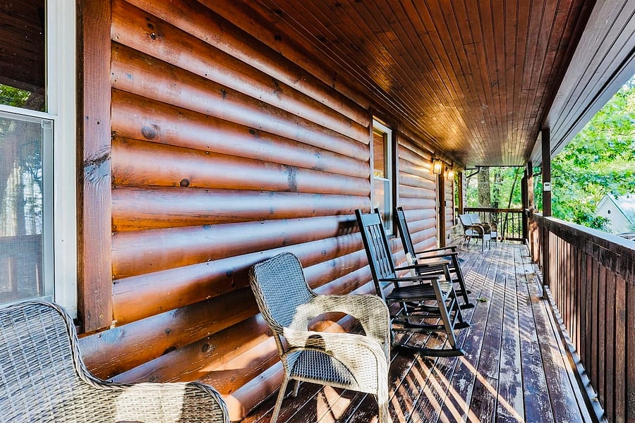 Front porch of the home overlooking the mountains with chairs and a swing!