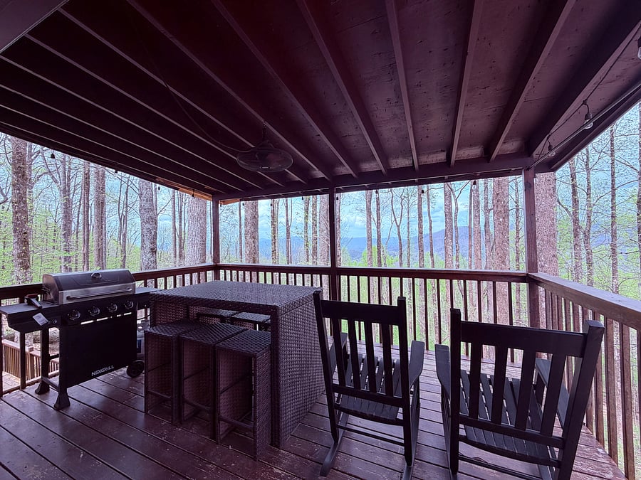 Main level deck right outside kitchen and living room space, propane gas grill. Seating for 6 and 2 rocking chairs.