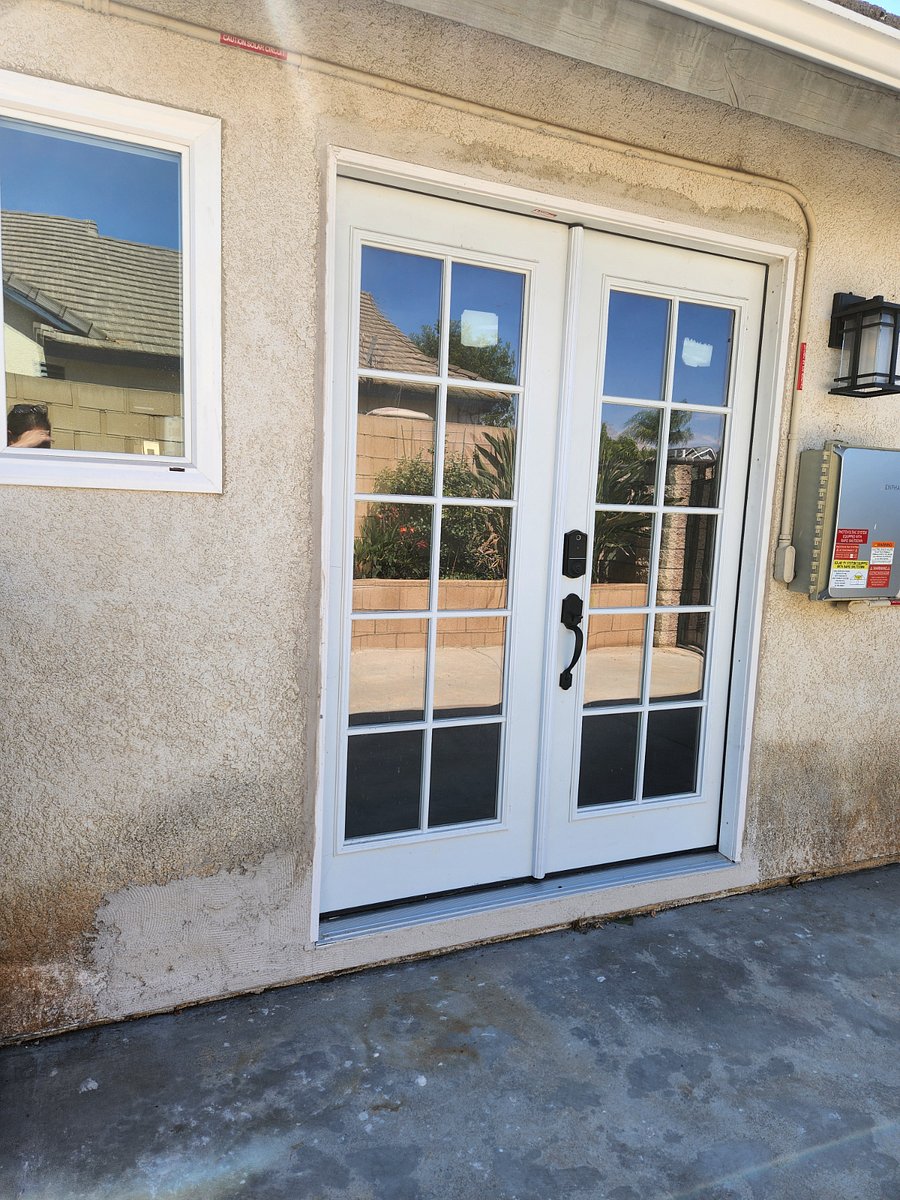 Front French Doors and Kitchen Window Exterior View.