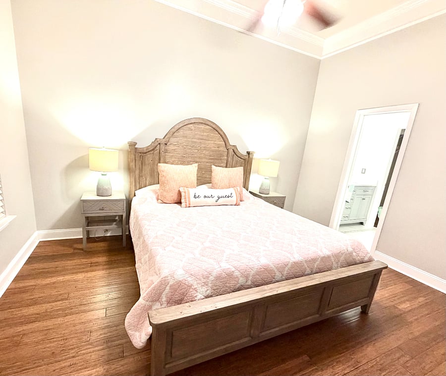 Downstairs primary bedroom with king bed, walk in closet and ensuite bathroom