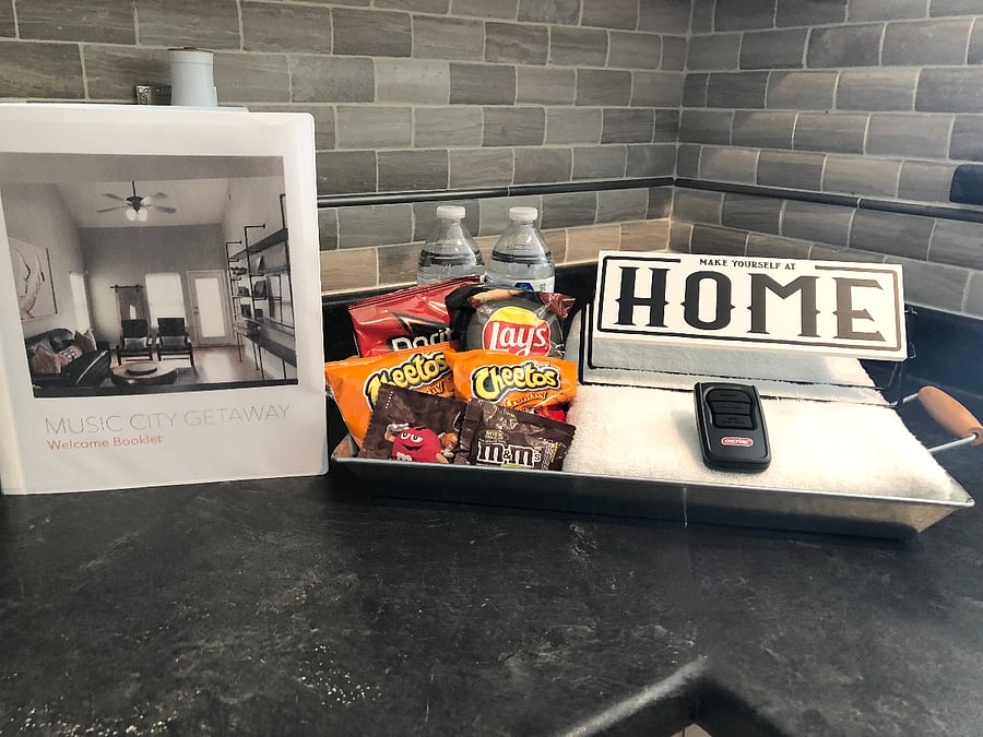 Welcome basket with treats and welcome book in kitchen