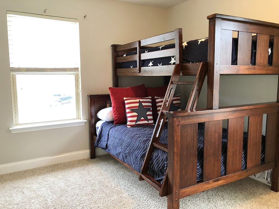 Bunk bed upstairs with full on bottom and single mattress on top