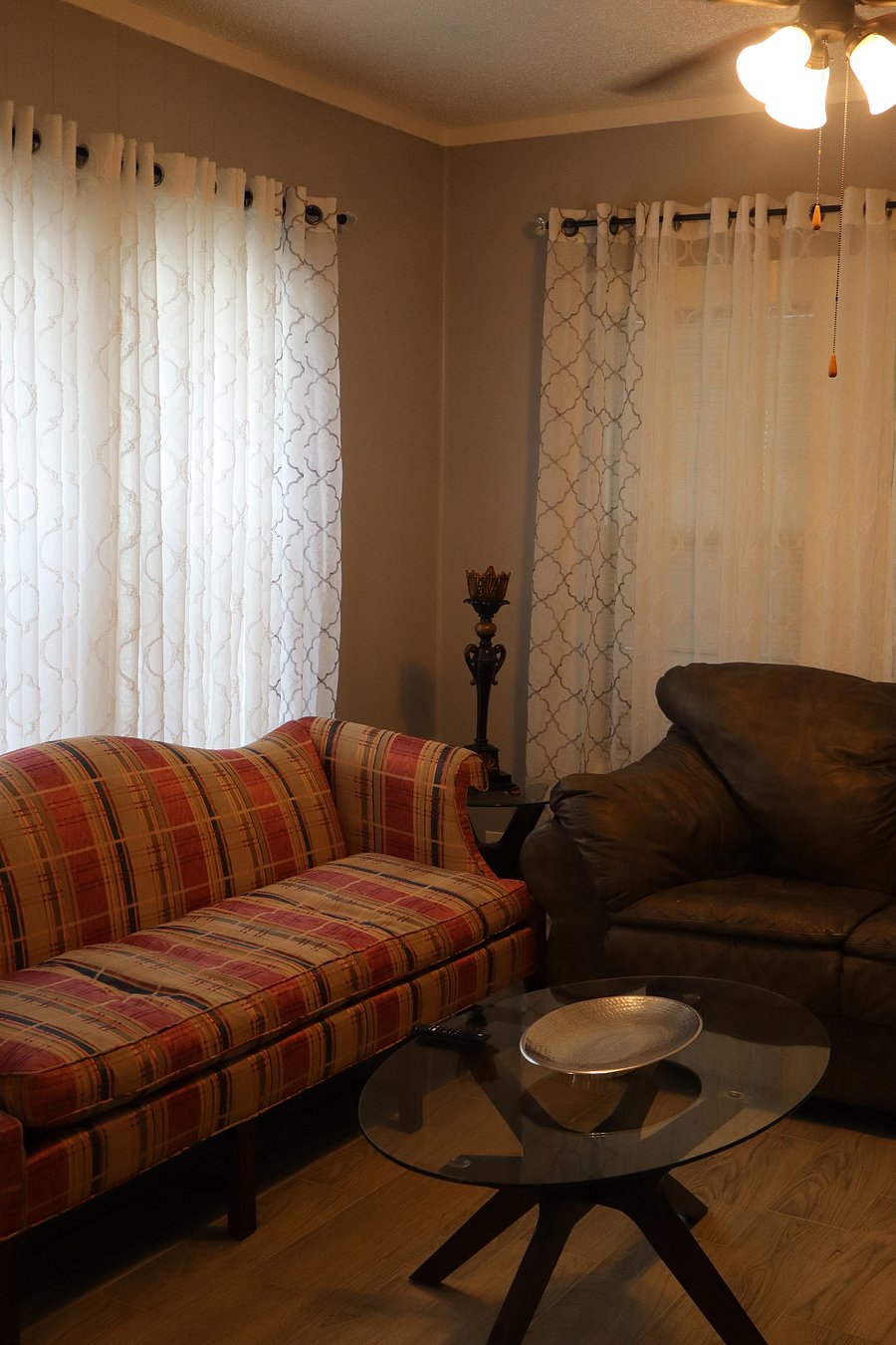 Living room with a fluffy super comfortable love seat and a colorful couch.