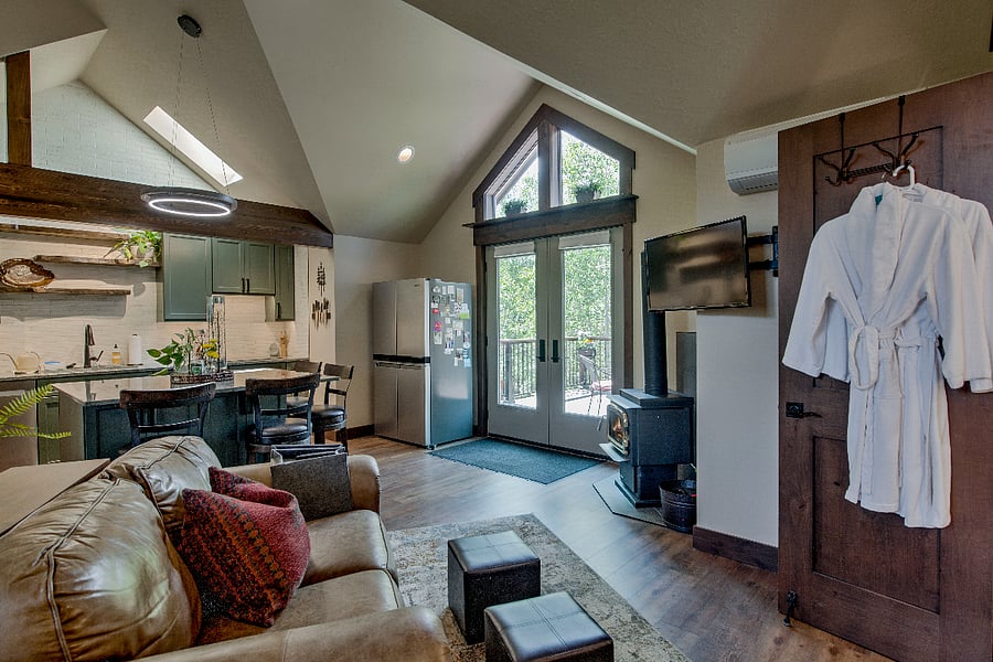 French doors onto the deck that also has a table, umbrella and 4 chairs.