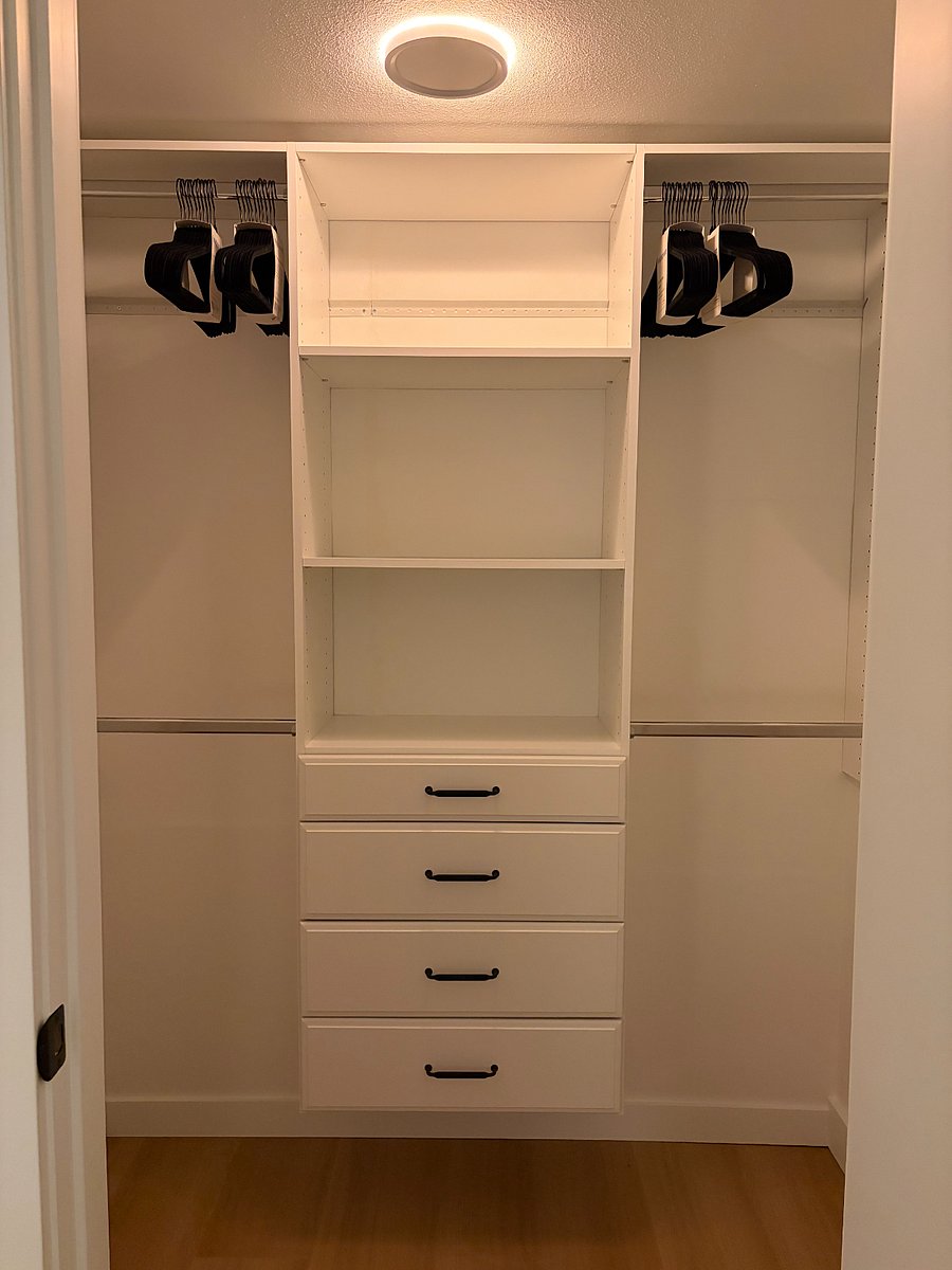 Spacious walk-in closet in primary bedroom with plenty of storage and multi-setting lighting