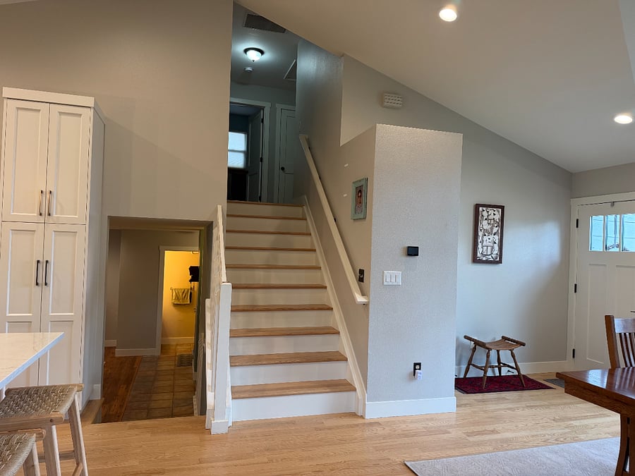 Stairs from main floor to upper level with bedrooms/baths
