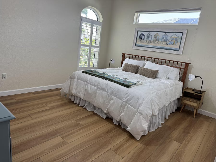 Bedroom 2 has a king-sized bed and a small TV.