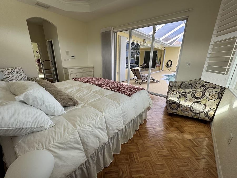 Primary bedroom opens to the lanai and pool.