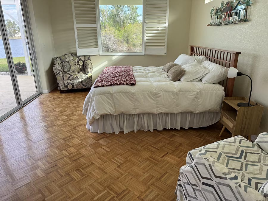 Spacious primary bedroom has a king-sized bed,