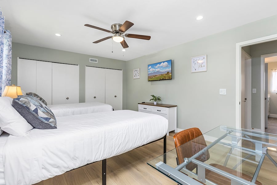 Second bedroom with smart TV & laptop workstation.