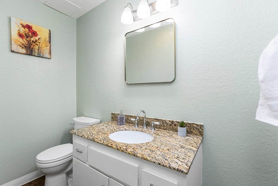 Half Bathroom (Downstairs) - Includes a toilet and vanity.