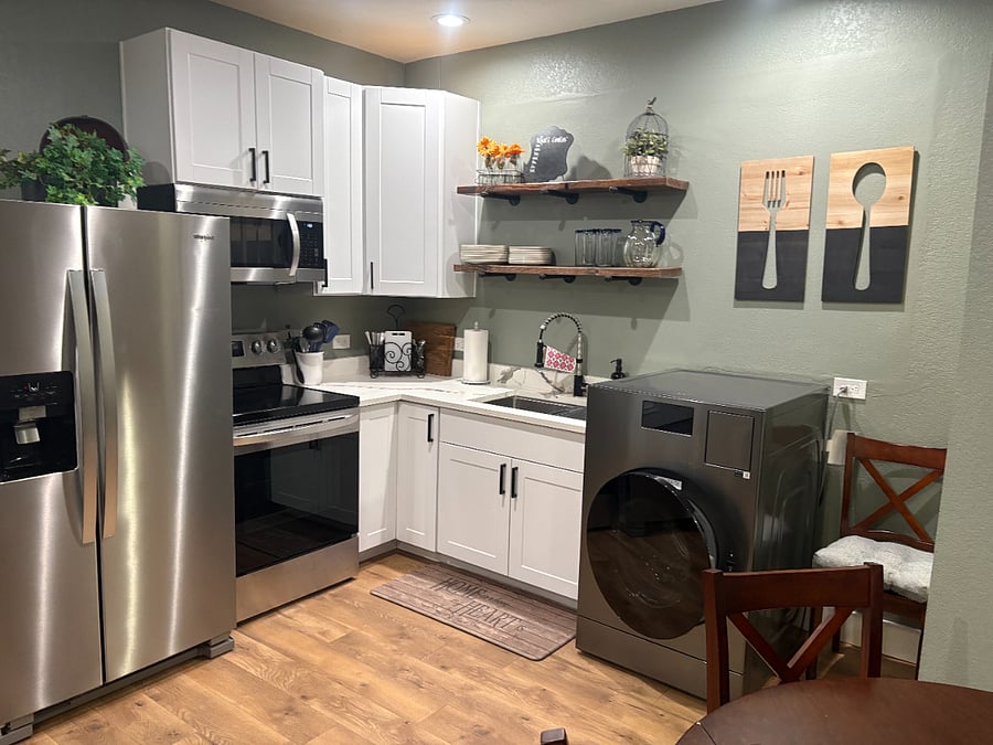 Kitchen with full refrigerator and range/oven