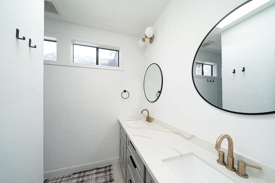 Bright, renovated bathroom with a skylight, generous counter space and dual vanity.