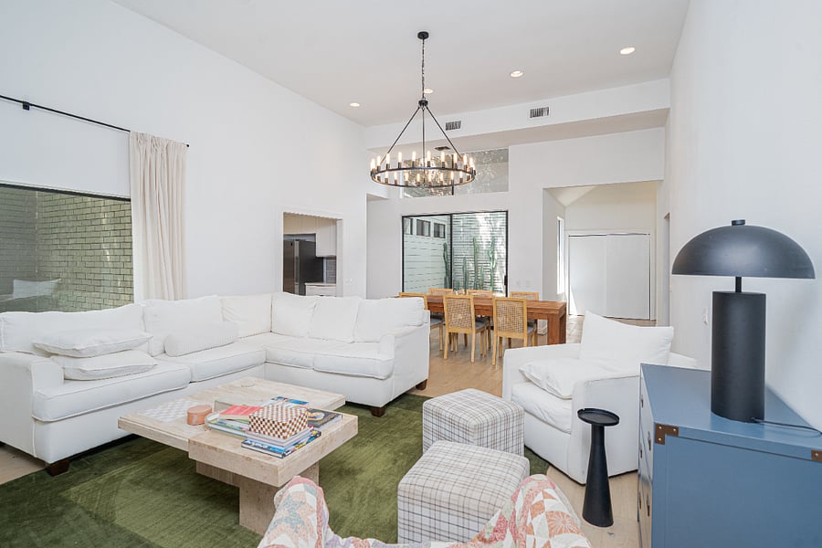 Bright, open-concept living area with comfortable seating, soaring ceilings, and natural light.